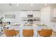 Kitchen island with seating, white cabinets, and quartz countertops at 11294 Linden Depot Rd, San Antonio, FL 33576