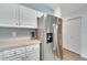 Stainless steel refrigerator in white kitchen with ample storage at 1013 Apollo Beach Blvd # 202, Apollo Beach, FL 33572