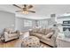 Living room with gray sofas, coffee table, and kitchen view at 1013 Apollo Beach Blvd # 202, Apollo Beach, FL 33572