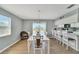 Dining area with white table and chairs near sliding glass door at 1013 Apollo Beach Blvd # 202, Apollo Beach, FL 33572