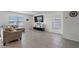 Living room with sectional sofa and large flat-screen TV at 602 Olive Conch St, Ruskin, FL 33570