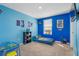 Fun bedroom with blue walls and a twin-size bed at 602 Olive Conch St, Ruskin, FL 33570