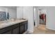 Clean bathroom with double sinks and a walk-in closet at 602 Olive Conch St, Ruskin, FL 33570