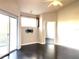 Living room with dark hardwood floors, sliding doors to balcony, and ceiling fan at 5125 Palm Springs Blvd # 9302, Tampa, FL 33647