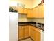 Well-maintained kitchen with light wood cabinets and dark countertops at 5125 Palm Springs Blvd # 9302, Tampa, FL 33647