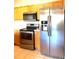 Stainless steel appliances and wood cabinets in this kitchen at 5125 Palm Springs Blvd # 9302, Tampa, FL 33647