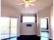 Living room with dark hardwood floors, sliding doors to balcony, and ceiling fan at 5125 Palm Springs Blvd # 9302, Tampa, FL 33647
