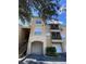 Exterior view of a three-story apartment building with parking and landscaping at 5125 Palm Springs Blvd # 9302, Tampa, FL 33647