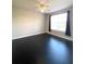 Spacious bedroom with dark hardwood floors and large window at 5125 Palm Springs Blvd # 9302, Tampa, FL 33647