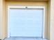 White garage door in a condo building at 5125 Palm Springs Blvd # 9302, Tampa, FL 33647