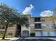 Exterior view of a three-story apartment building with parking and landscaping at 5125 Palm Springs Blvd # 9302, Tampa, FL 33647