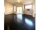 Living room with dark hardwood floors, sliding doors to balcony, and ceiling fan at 5125 Palm Springs Blvd # 9302, Tampa, FL 33647