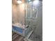 Bathroom with a soaking tub, glass shower, and marble tile at 777 N Ashley Dr # 1103, Tampa, FL 33602