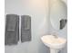 Small bathroom with pedestal sink and gray towels at 2530 Leonia Ln, Zephyrhills, FL 33541