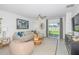 Spacious living room with light beige sectional sofa and large window at 2530 Leonia Ln, Zephyrhills, FL 33541