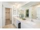 Double vanity bathroom with a walk-in shower and large mirror at 2530 Leonia Ln, Zephyrhills, FL 33541