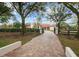 Long paver driveway leading to a luxury estate at 11623 Innfields Dr, Odessa, FL 33556
