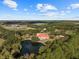 Aerial view of home with pool and pond at 11623 Innfields Dr, Odessa, FL 33556