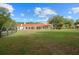 Large backyard with sprawling lawn and view of the home's back at 11623 Innfields Dr, Odessa, FL 33556