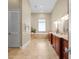 Luxurious bathroom with double vanity, soaking tub, and tile flooring at 11623 Innfields Dr, Odessa, FL 33556