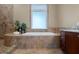 Bathroom with soaking tub, walk-in shower and large window at 11623 Innfields Dr, Odessa, FL 33556