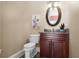 Stylish powder room with dark wood vanity and granite countertop at 11623 Innfields Dr, Odessa, FL 33556