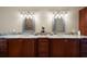 Double vanity bathroom with granite countertop and large mirrors at 11623 Innfields Dr, Odessa, FL 33556