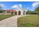 Home exterior showcasing a red tile roof and a large lawn at 11623 Innfields Dr, Odessa, FL 33556
