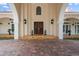Home's entrance with double doors and arched entryway at 11623 Innfields Dr, Odessa, FL 33556