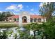 Grand estate home with red tile roof, fountain, and lush landscaping at 11623 Innfields Dr, Odessa, FL 33556