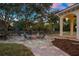 Cozy fire pit area with seating, surrounded by landscaping at 11623 Innfields Dr, Odessa, FL 33556