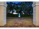 Evening view of a tranquil fountain framed by elegant archways at 11623 Innfields Dr, Odessa, FL 33556