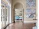 Sunlit hallway with hardwood floors and views of the living area at 11623 Innfields Dr, Odessa, FL 33556