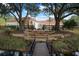 Back of house with stone steps leading to a wooden bridge over a canal at 11623 Innfields Dr, Odessa, FL 33556