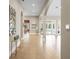 Long hallway with tile floors, arched entryways and access to other rooms at 11623 Innfields Dr, Odessa, FL 33556