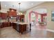 Gourmet kitchen boasts granite countertops, stainless steel appliances, and rich wood cabinetry at 11623 Innfields Dr, Odessa, FL 33556