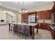Open kitchen with large island, granite counters, and stainless steel appliances at 11623 Innfields Dr, Odessa, FL 33556