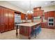Island kitchen with stainless steel appliances and ample wood cabinetry at 11623 Innfields Dr, Odessa, FL 33556
