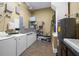 Shared laundry room with washer, dryer, and ample storage at 11623 Innfields Dr, Odessa, FL 33556