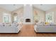 Large living room with hardwood floors, fireplace, and lots of natural light at 11623 Innfields Dr, Odessa, FL 33556