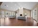 Spacious living room with hardwood floors, fireplace, and multiple seating areas at 11623 Innfields Dr, Odessa, FL 33556