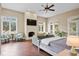 Main bedroom with fireplace, hardwood floors, and multiple seating areas at 11623 Innfields Dr, Odessa, FL 33556