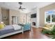 Large main bedroom with fireplace, sitting area, and hardwood floors at 11623 Innfields Dr, Odessa, FL 33556