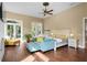 Spacious main bedroom with hardwood floors, seating area, and access to backyard at 11623 Innfields Dr, Odessa, FL 33556