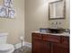 Powder room with glass vessel sink and dark wood vanity at 11623 Innfields Dr, Odessa, FL 33556