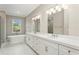 Elegant bathroom with double vanity, soaking tub, and walk-in shower at 6434 Rubia Cir, Apollo Beach, FL 33572