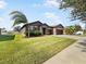 Single-story home with a two-car garage and landscaped lawn at 1509 Banner Elk St, Valrico, FL 33594