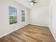 Well-lit bedroom with ceiling fan and wood-look flooring at 1509 Banner Elk St, Valrico, FL 33594