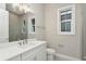 Bathroom with single vanity, white cabinets, and a window at 6434 Rubia Cir, Apollo Beach, FL 33572