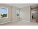 Bright bedroom with two windows, carpeting, and access to a hallway at 6434 Rubia Cir, Apollo Beach, FL 33572